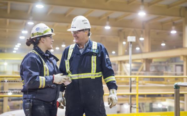 Two people talking in safety gear